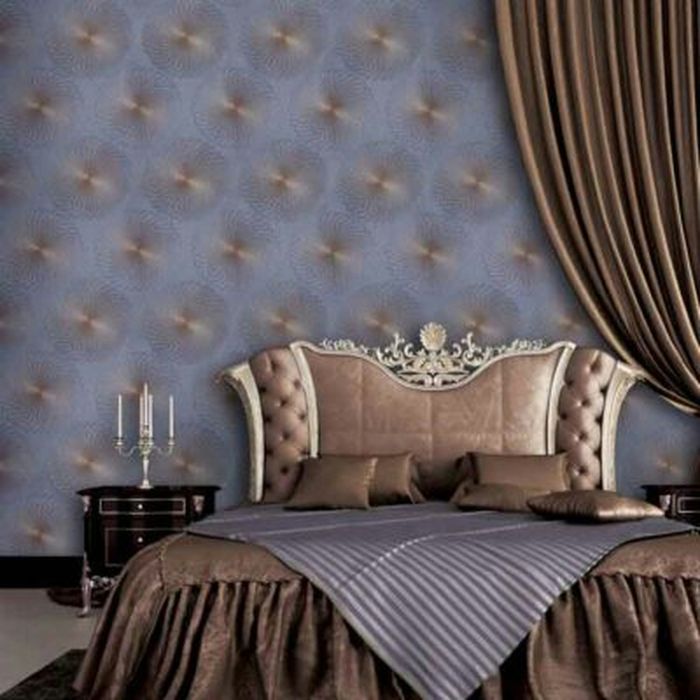 Bedroom with lilac quilted-effect wallcovering, an ornate upholstered headboard and bronze drapery
